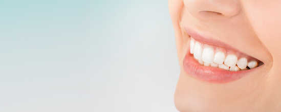 Beautiful smile young woman. White teeth on the master plan. Beautiful smile young woman. White teeth on the master plan. Free space and background to use.