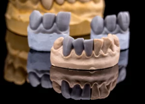 Mehrere Gebisse mit Zahnprothesen liegen nebeneinander.